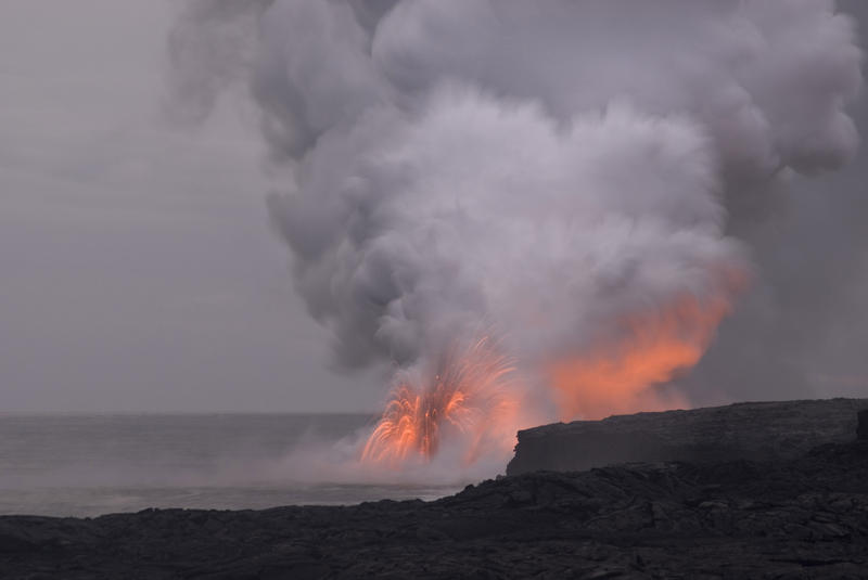 lava exploding from the sea creating clouds of hot volcanic gasses on hawaiiis big island, Hawaii, USA