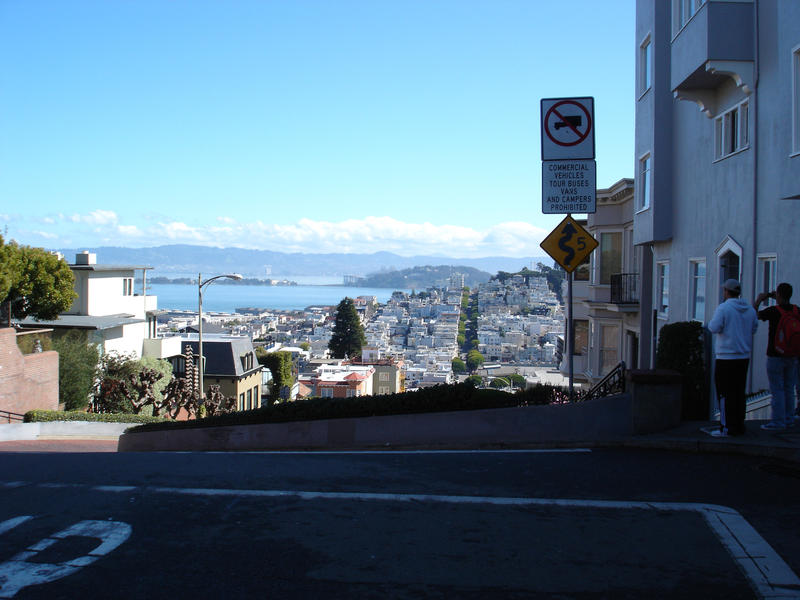 tourists looking at the view from the top of lombard street, san francisco