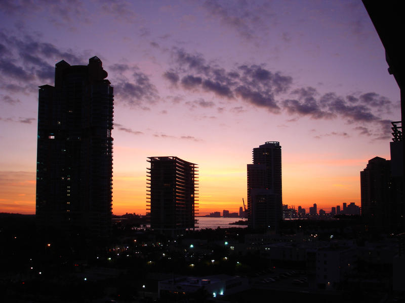 Beautiful vivid Miami sunset with tall skyscrapers and hotels silhouetted against the dramatic sky
