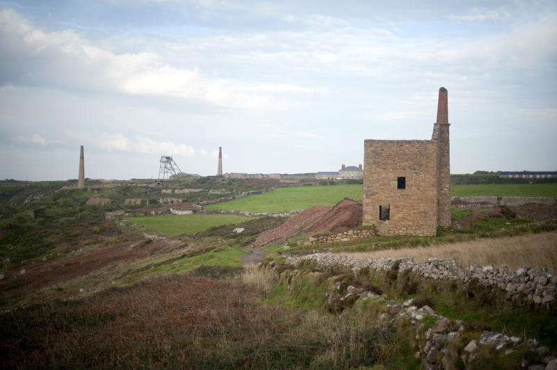 Botallack mining landscape near St Just with the ruins of an engine house with headgear and chimneys in the background now part of the Cornwall and West Devon Mining Landscape World Heritage site