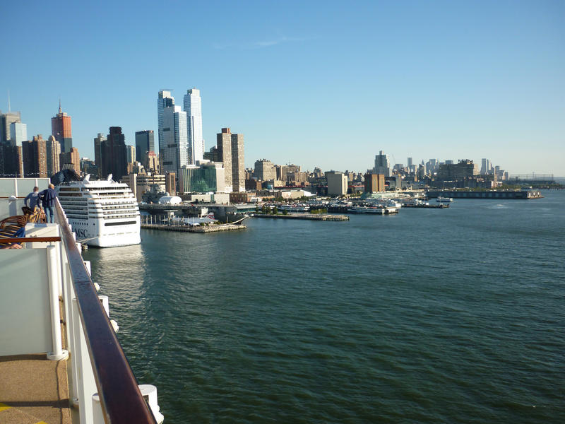 View of passenger liners in dock at the New York cruise terminal with New York city on the skyline