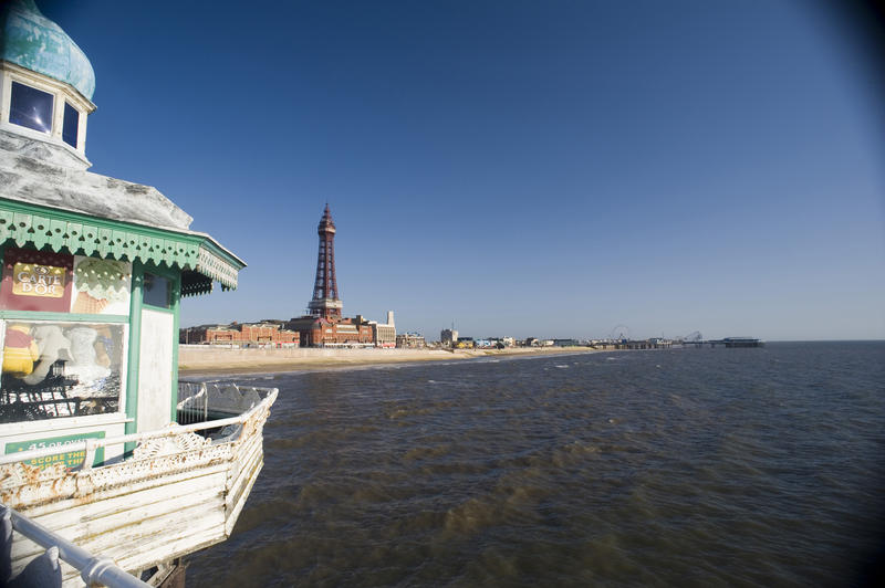 Blackpool from the North Pier looking past a quaint ornate Victorian kiosk to the waterfront and historical Blackpool Tower