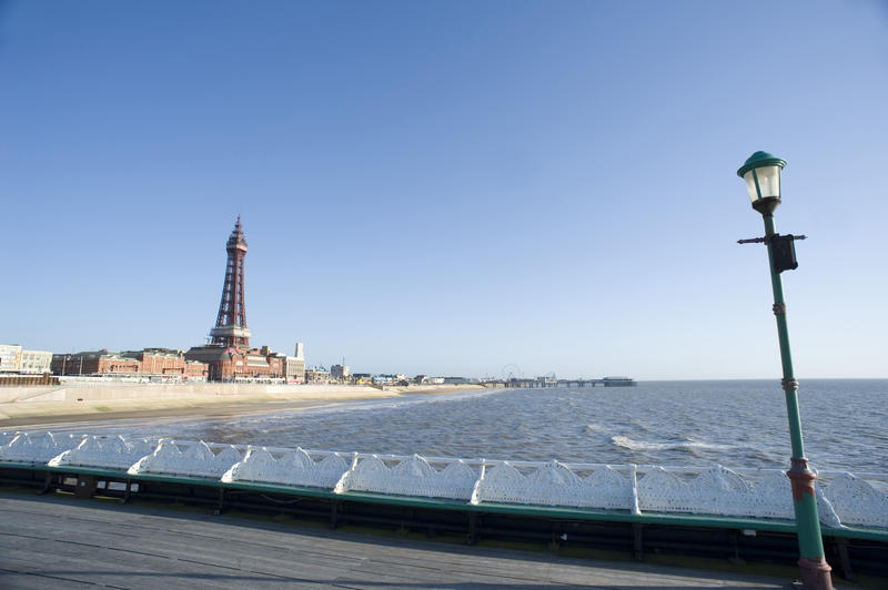 View of Blackpool from the north pier looking over the sea towards the Blackpool Tower, beach and waterfront