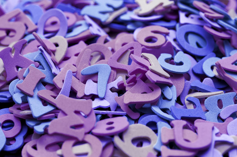 An assortment of random purple numbers and uppercase letters for teaching young children languages and mathematics in an educational background