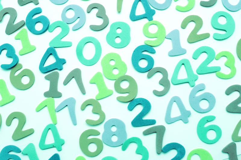 Spread out numbers on white background in a variety of greens