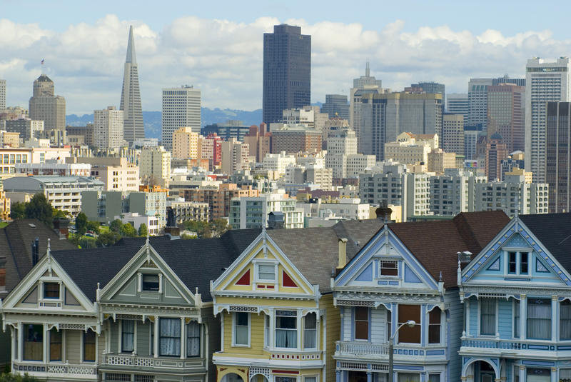 colourful houses at alamo square with the san francisco city skyline on the back ground - not property released