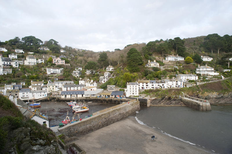 View of the harbour and quaint white painted cottages in the traditional unspoilt Polperro fishing village in Cornwall