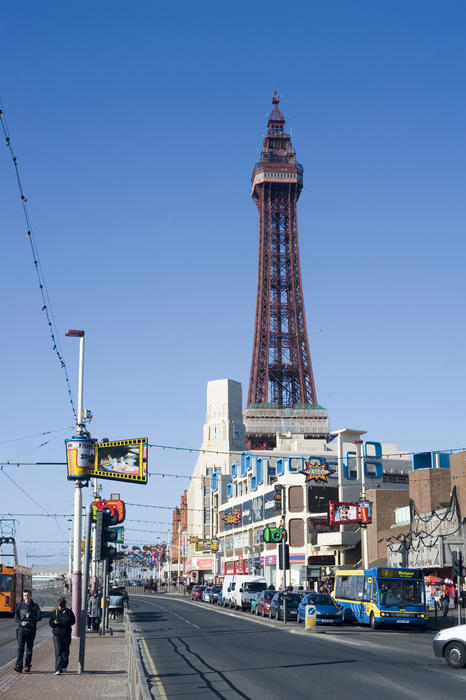 View along the busy waterfront Promenade with its traffic and people towards the Blackpool Tower