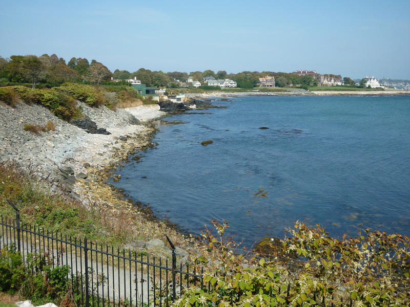 View of the Rhode Island coastline looking along a bay and beach towards waterfront properties in the distance