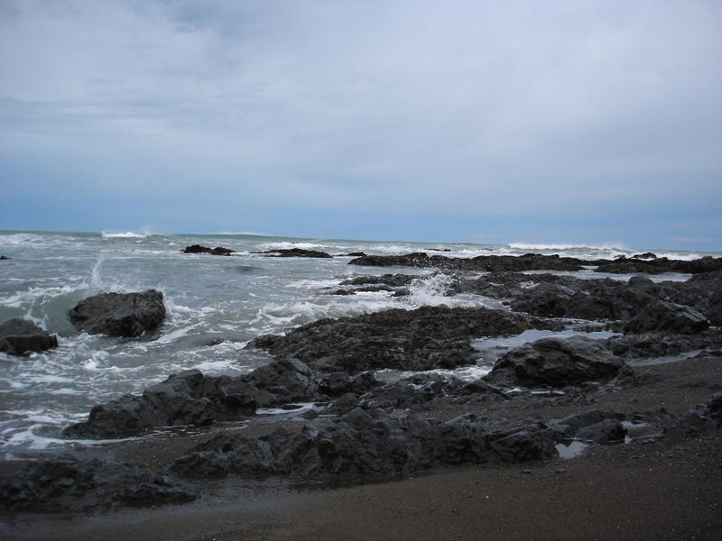 waves breaking on a jagged rocky coastline