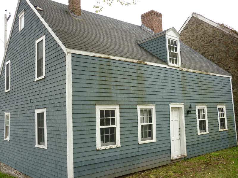Traditional shingle house construction with overlapping wooden planks cladding the walls in Nova Scotia, Canada