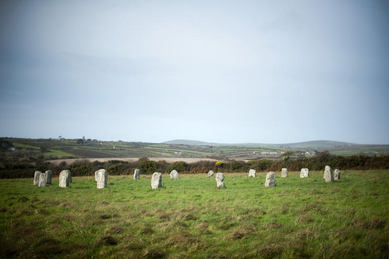 A landscape view of the complete Merry Maidens stone circle, a neolithic formation consisting of nineteen granite megaliths arranged in a perfect circle near St Buryan, Cornwall