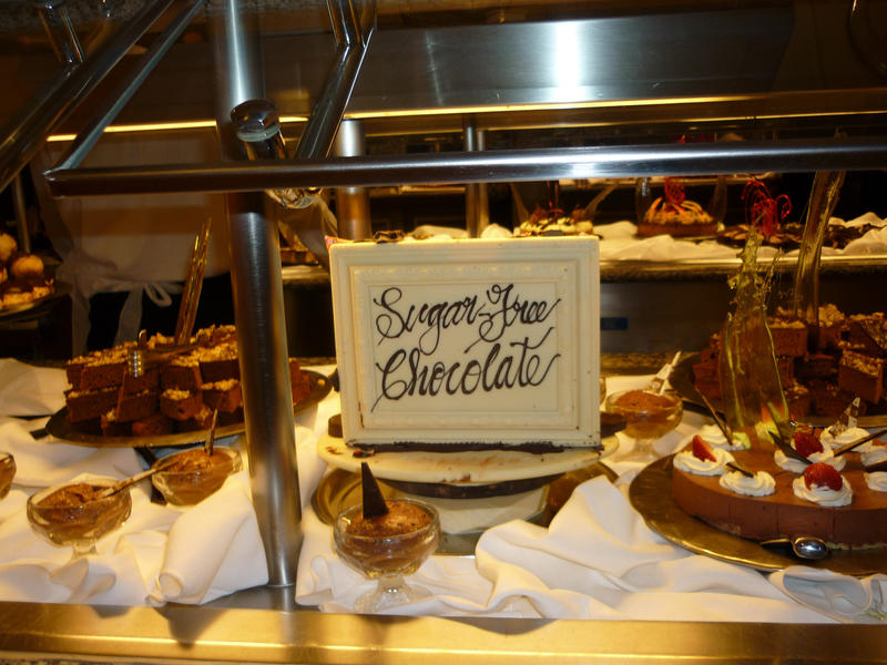 Sugar-free chcocolate products on dsiplay in a glass counter at a bakery with cakes, desserts and candy