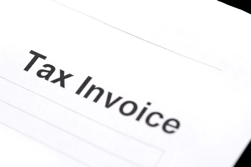 Closeup of a blank tax invoice header document angled diagonally on white