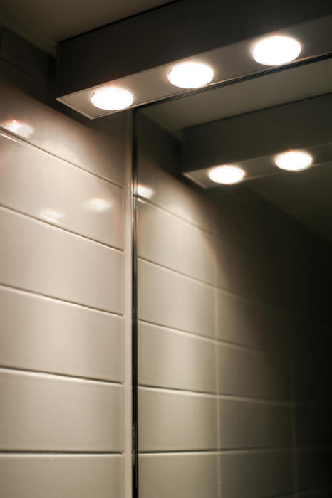 bright lighting above a bathroom vanity mirror