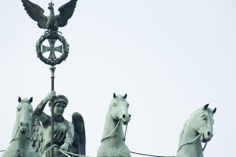 Detail of the bronze statue on the top of the Brandenburg Gate, Berlin, depicting a four-horse chariot being driven by Victoria, the winged Goddess of victory