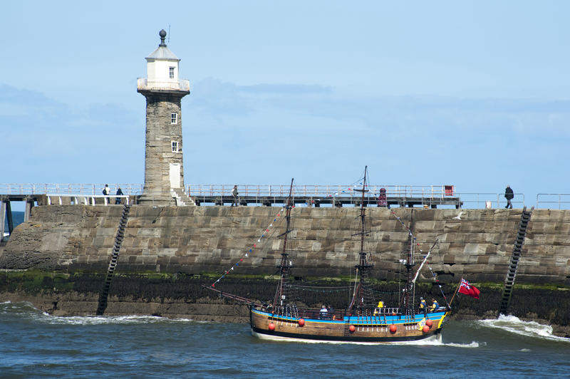 Whitby East Pier and Bark Endeavour replica, a full sized scale moodel of Captain Cooks ship which offers trips along the Whitby coastline