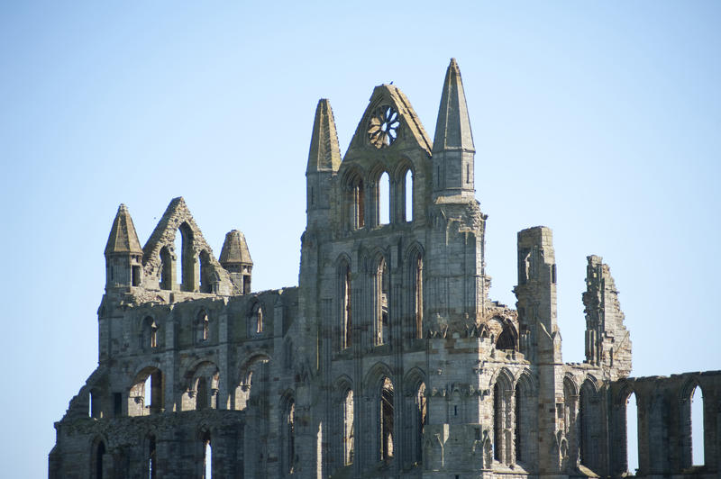Majestic ruins of Whitby Abbey on the North Yorkshire coast against a clear blue sky