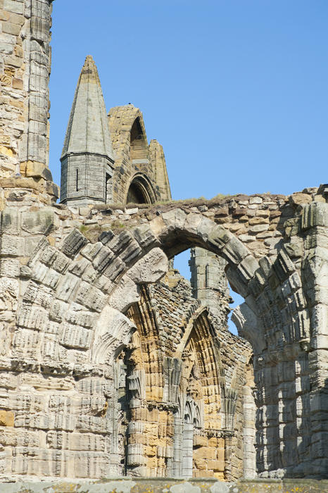 Whitby Abbey ruins with its stone medieval arches, a former Benedictine monastery destroyed under King Henry VIII in North Yorkshire
