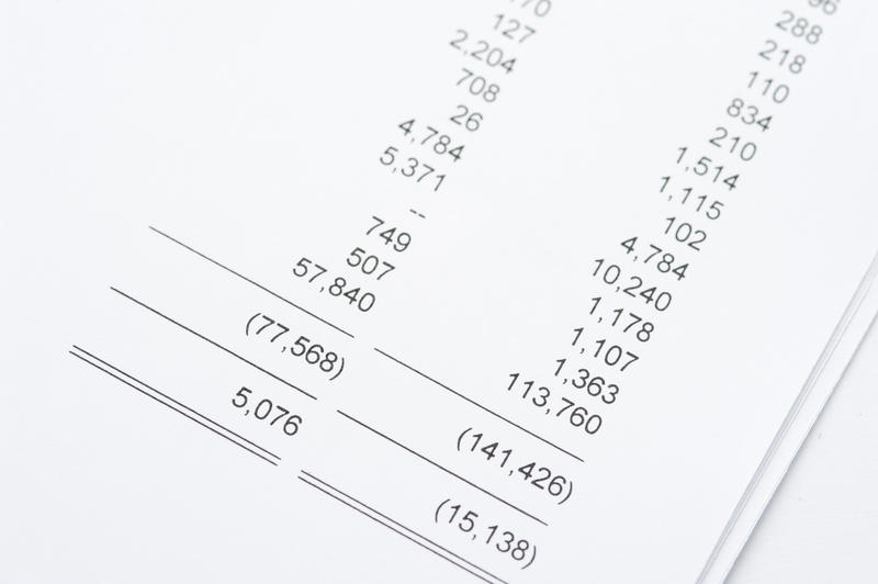 Close up Summary of Accounts Reports Printed on White Papers Placed on the Table.