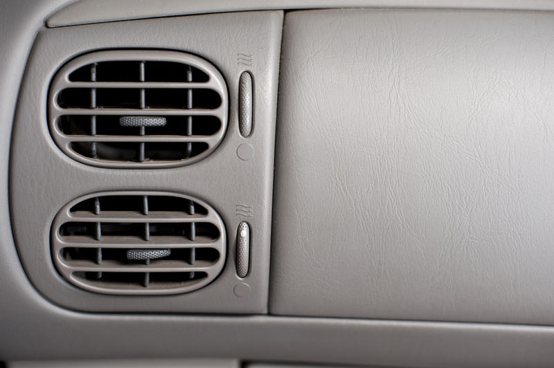 Close up Two Air Conditioner Vents System on a Gray Interior Wall of a Car