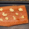 10602   Slice of Baked Salmon with Butter on Top on a Tray
