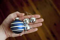 11697   Man holding silver bells and a Christmas bauble
