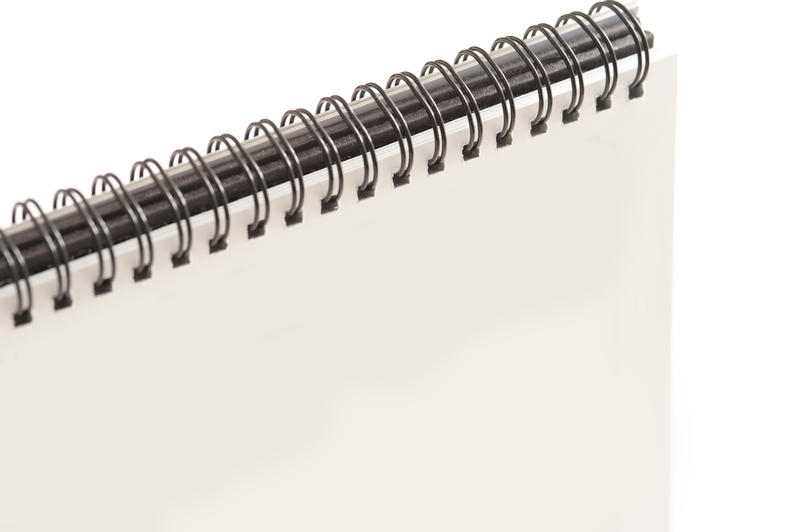 Close up Blank White Spiral Notebook with Copy Space for Texts on White Background.