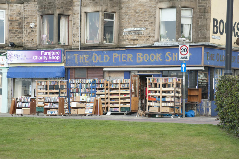 The Old Pier Bookshop in Morcambe Lancashire with portable shelving laden with stock on display outside