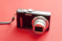 10670   Digital Camera Isolated on Red Background