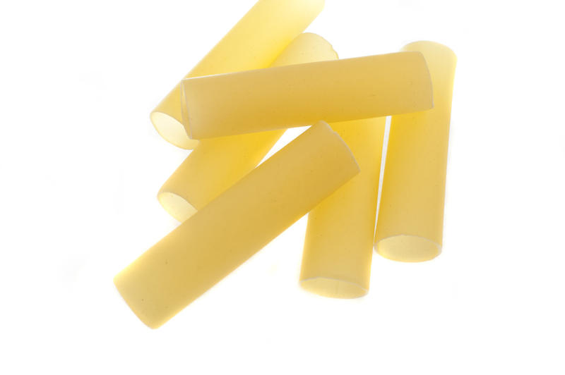 Dried uncooked Italian cannelloni tubes for cooking traditional Mediterranean pasta or noodle recipes, viewed from above on white