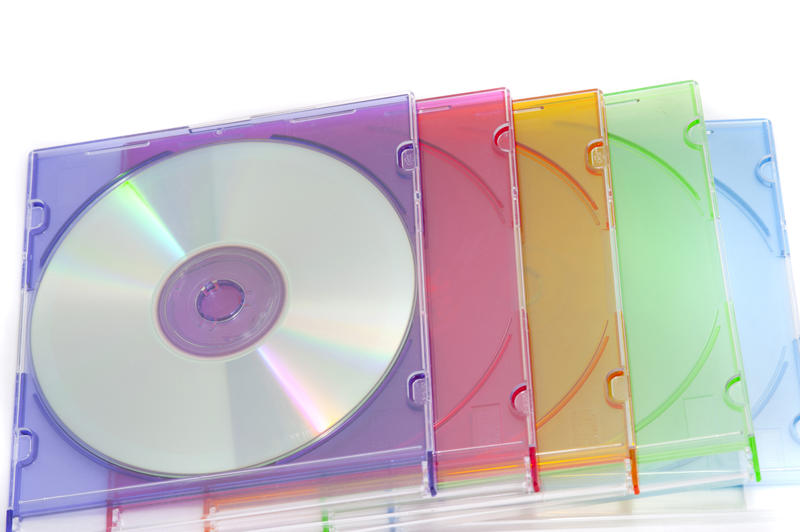 Close up Pile of Colorful Compact Disc Cases Isolated on White Background