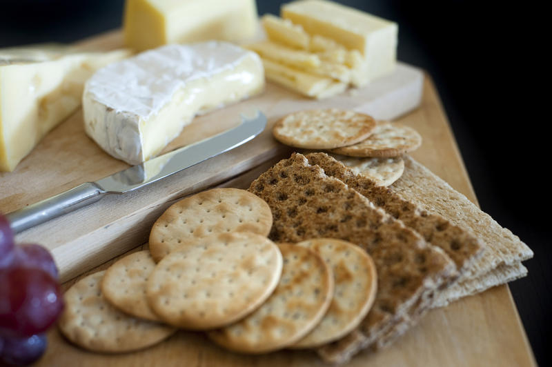 Cheeseboard with assorted cheeses served with crispbread or wheat crackers and water biscuits on a buffet as an appetizer