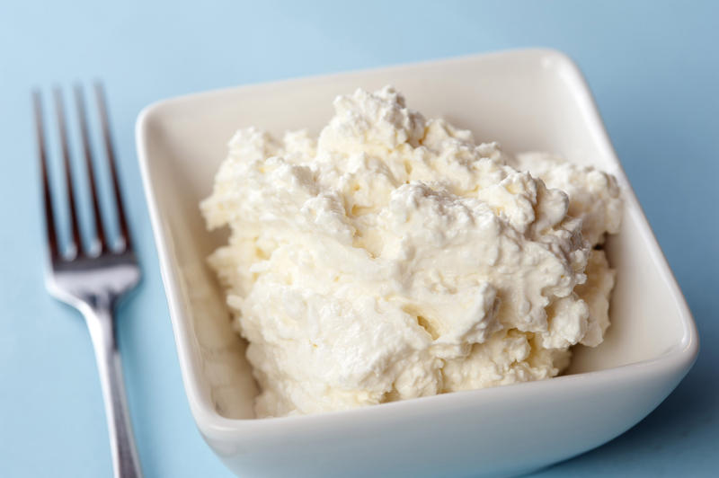 Dish of cottage cheese, a soft white cheese formed from the curds of skim milk