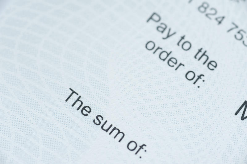 Close up Computerized Text Prints on a Cheque Emphasizing the Sum Label.