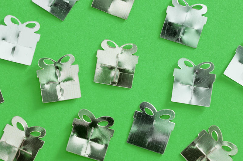 randomly arranged party of festive present shapes on a green background