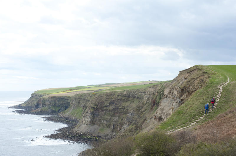 Walkers enjoying a ramble along the Cleveland Way pathway as it meanders across the scenic headlands of the Yorkshire coast