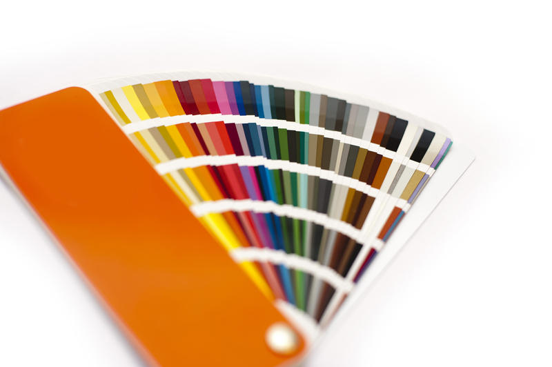 Opened color chart for painting or interior decorating fanned to show the colors of the spectrum in various hues and shades, on white