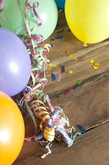 Party decorations border of colorful balloons and coiled paper streamers with copyspace for your invitation to a celebration