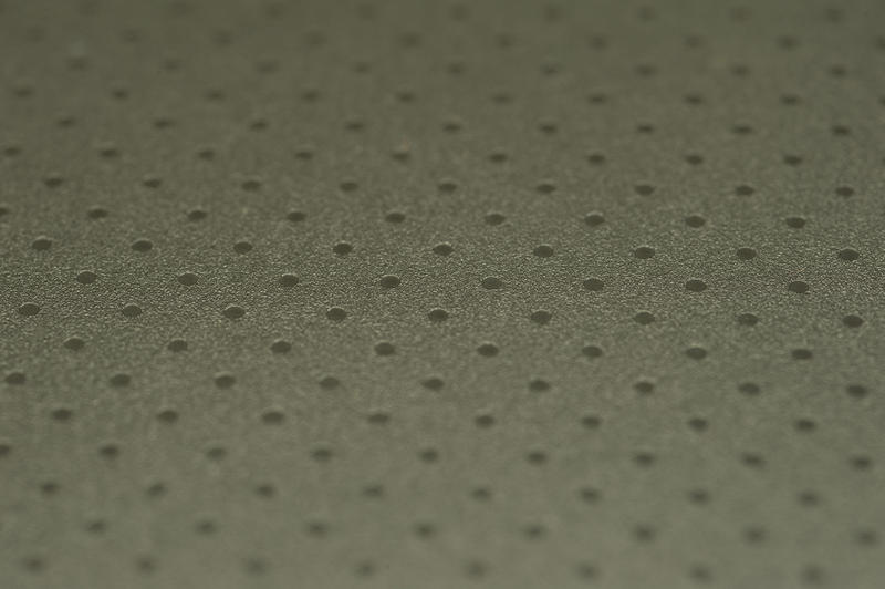 A dark background pattern of a surface with isometric dots
