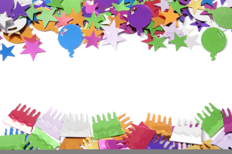 Festive border of multicolored confetti in a variety of shapes on a white background with copyspace for your invitation to a party celebration or event