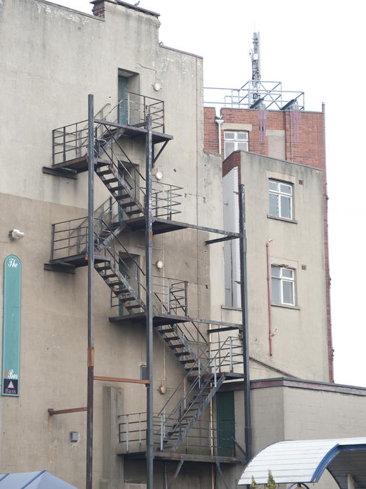 Metal fire escape on the outside wall of an urban building providing an emergency exit in the event of fire