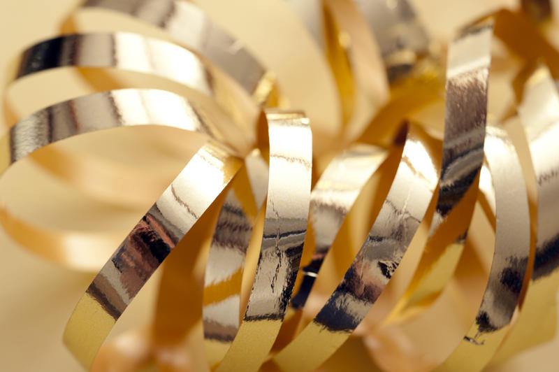 Close Up Still Life of Shiny Gold Ribbon Curl, Macro Shot of Decorative Metallic Wrapping Supplies