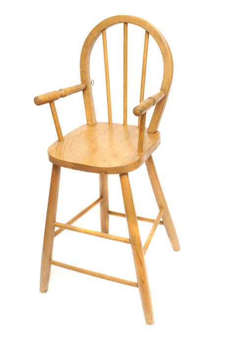 Bentwood high chair with a spindle back for feeding a baby or toddler at a height convenient to the mother, isolated on white