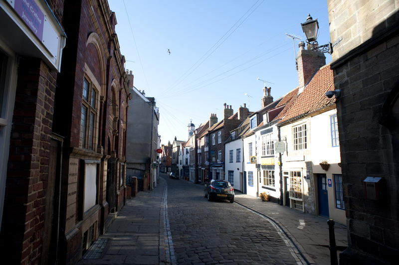 Church Street in Whitby, Yorkshire which is one of the oldest shopping streets and leads all the way through the town to the 199 steps leading to St Marys Church