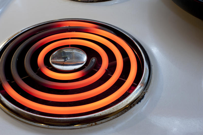 Red hot spiral hotplate on a stove top or hob, a source of power and energy for cooking in the kitchen