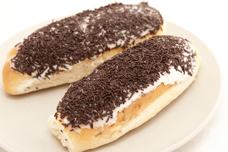 Freshly buns topped with chocolate sprinkles on a plate for a tasty dessert or refreshments for a coffee break