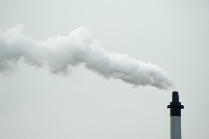 Gray Smoke From Industrial Chimney on Gray Sky Background