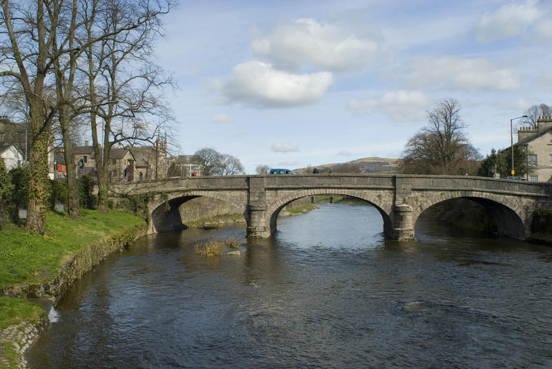 Picturesque arched stone bridge at Kendal, a market town in the English Lake District in Cumbria