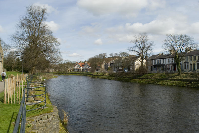River Kent flowing through the picturesque market town of Kendal in Cumbria past traditional old English houses